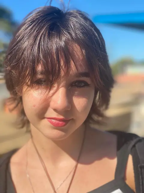Front view of a textured brunette shag with a wispy fringe